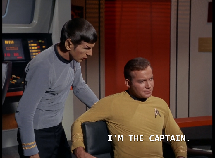 Kirk sitting in the captain’s chair on the bridge and saying, “I’m the captain” while Spock stands behind the chair with a rather confused look on his face.